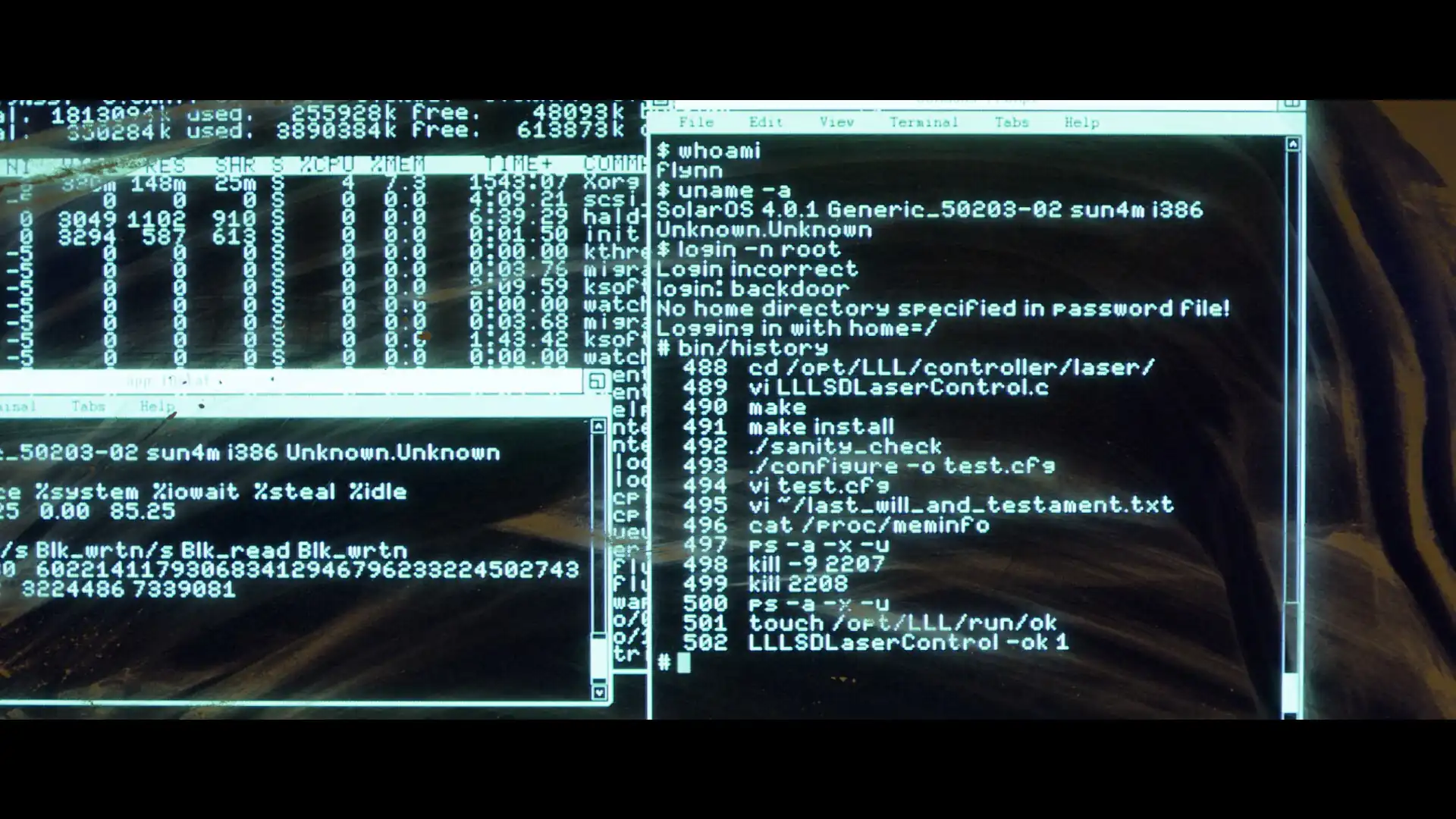 A photograph of a retro light-cyan-on-black screen. On the background, htop lists processes, like Xorg, init, and kthread. On the foreground, a retro-style terminal window is shown running commands like 'whoami', 'login -n root', and 'bin/history', with the history containing common shell commands like 'make', './configure', 'cat /proc/meminfo', etc. The commands mention a laser and a file called last_will_and_testament.txt, enacting technopunk vibes. A photograph of a retro light-cyan-on-black screen. On the background, htop lists processes, like Xorg, init, and kthread. On the foreground, a retro-style terminal window is shown running commands like 'whoami', 'login -n root', and 'bin/history', with the history containing common shell commands like 'make', './configure', 'cat /proc/meminfo', etc. The commands mention a laser and a file called last_will_and_testament.txt, enacting technopunk vibes.